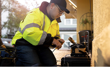 A man preparing fiber internet installation outside a home.