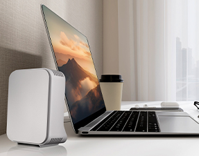 A laptop next to a WiFi extender