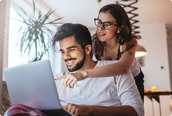  A couple reading an easy to understand internet bill on a laptop.