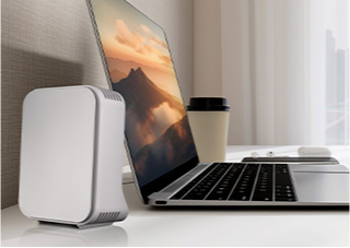 A laptop next to a WiFi extender